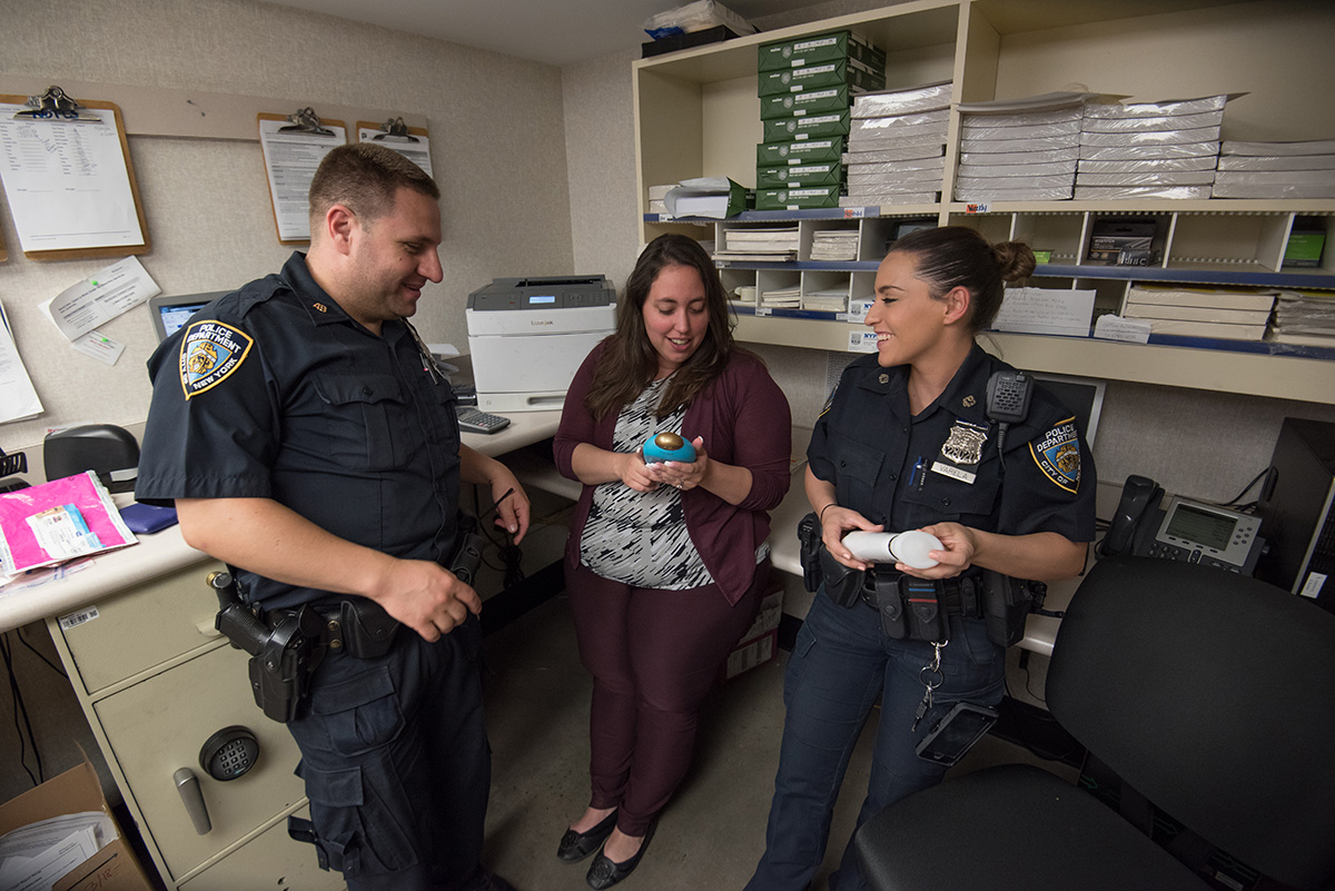 Cannova and Varela talking with the manager of a neighborhood drugstore