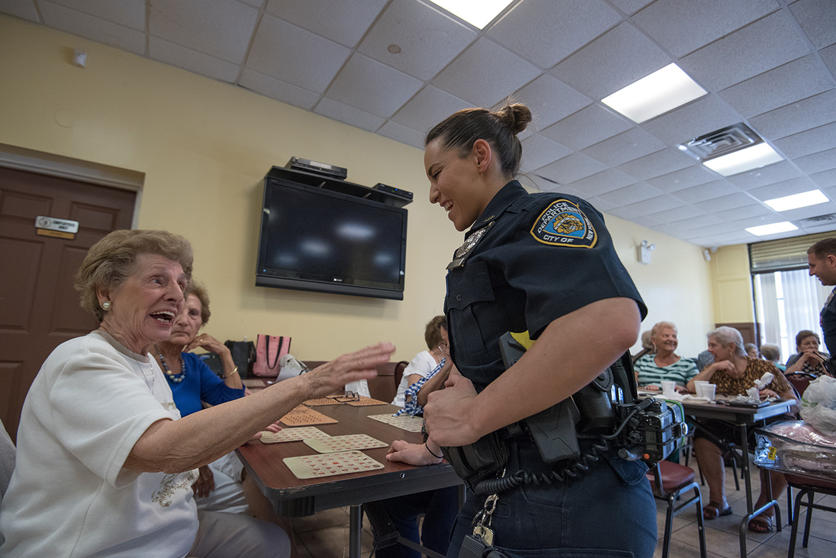 Varela chatting with elderly community members