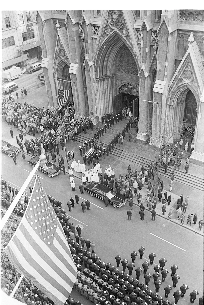 Arial view of funeral processsion outside St. Patrick's Cathedral, police officers saluting