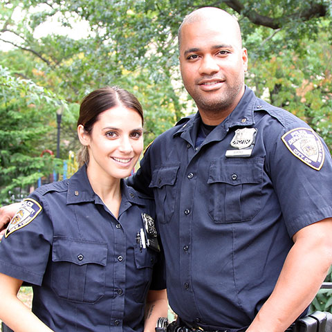 Smiling female and male police officers