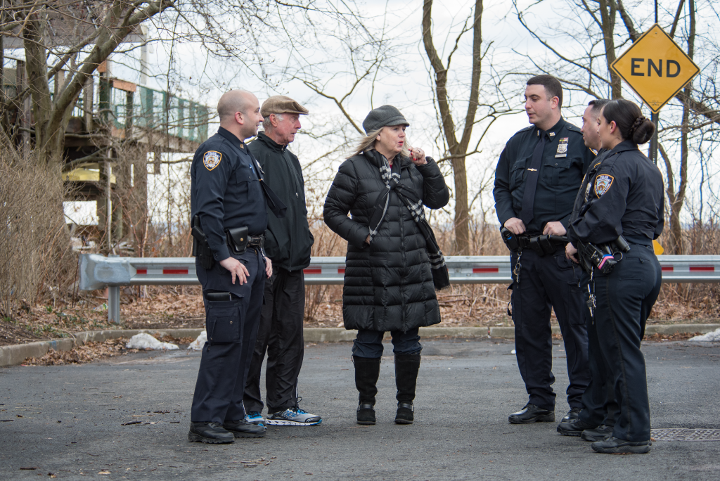 Residents standing and talking to police officers
