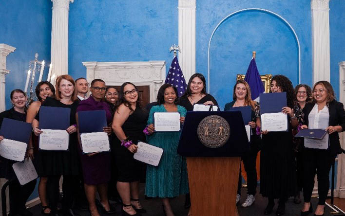 A group of people holding certificates