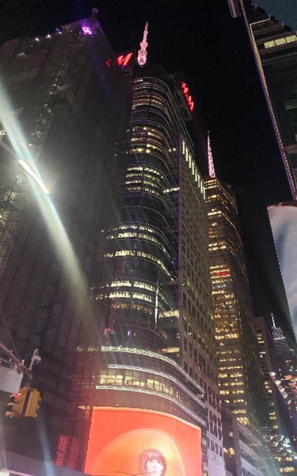 Outside view of Bank of America Building illuminated in orange lights.