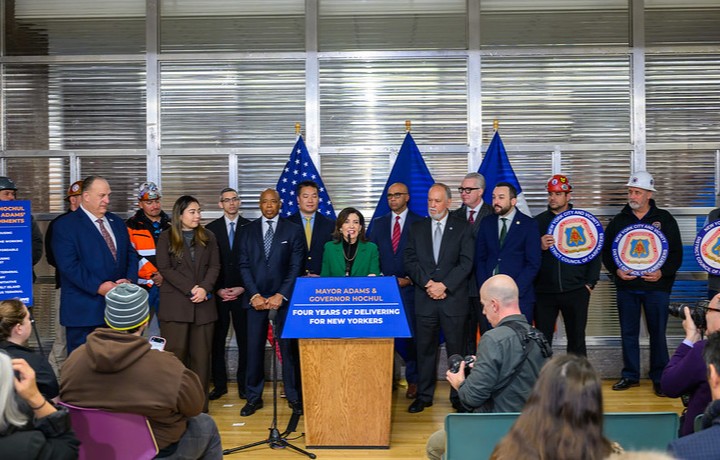 Governor Kathy Hochul speaking at podium with Mayor Eric Adams, Chief Medical Dr. Jason Graham and officials gathered at the SPARC Kips Bay groundbreaking
                                           