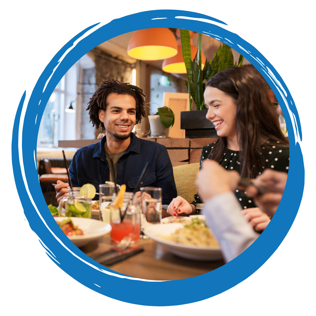 Smiling people sitting together at a table