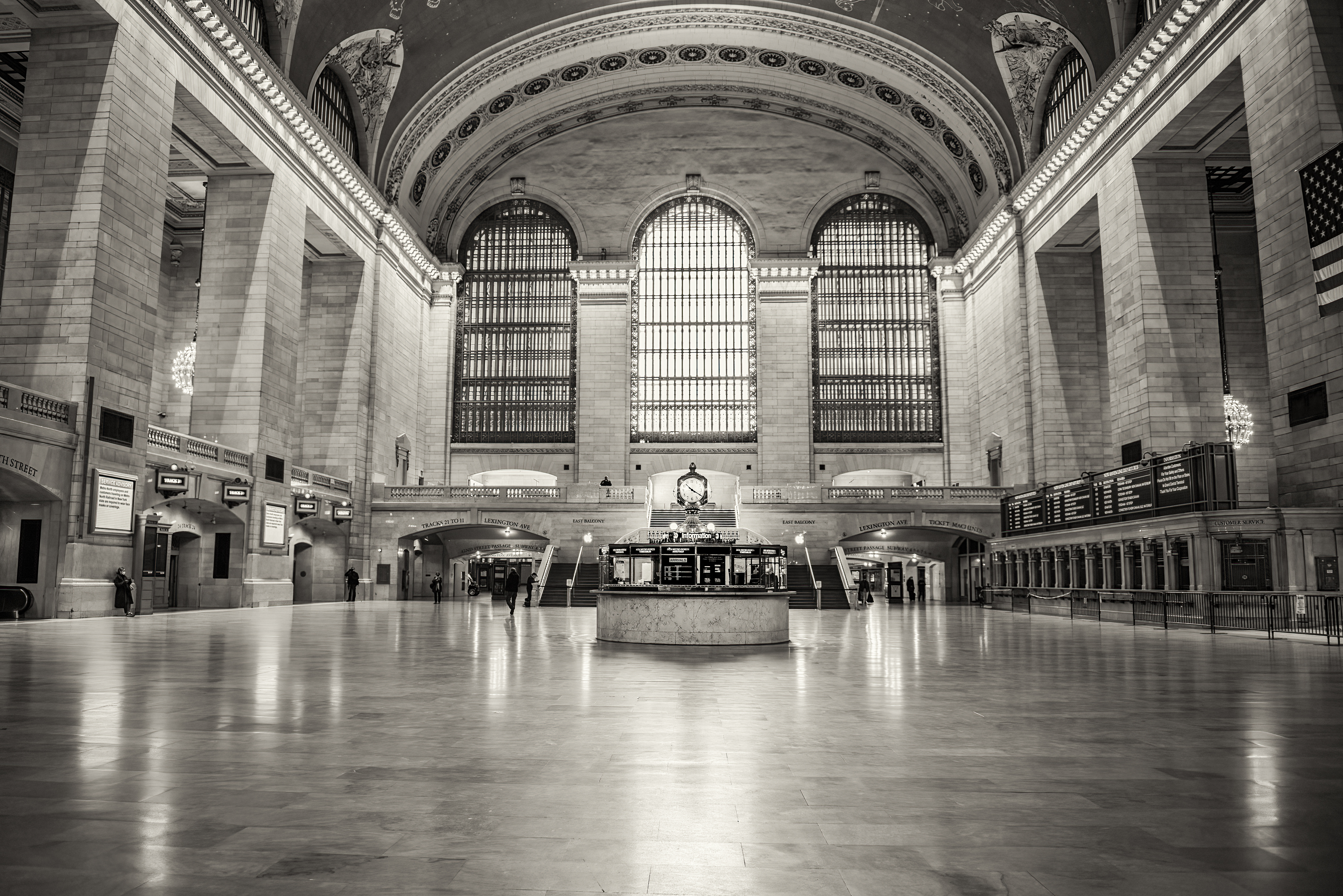 This is a black and white photo of grand central station in NYC.
                                           