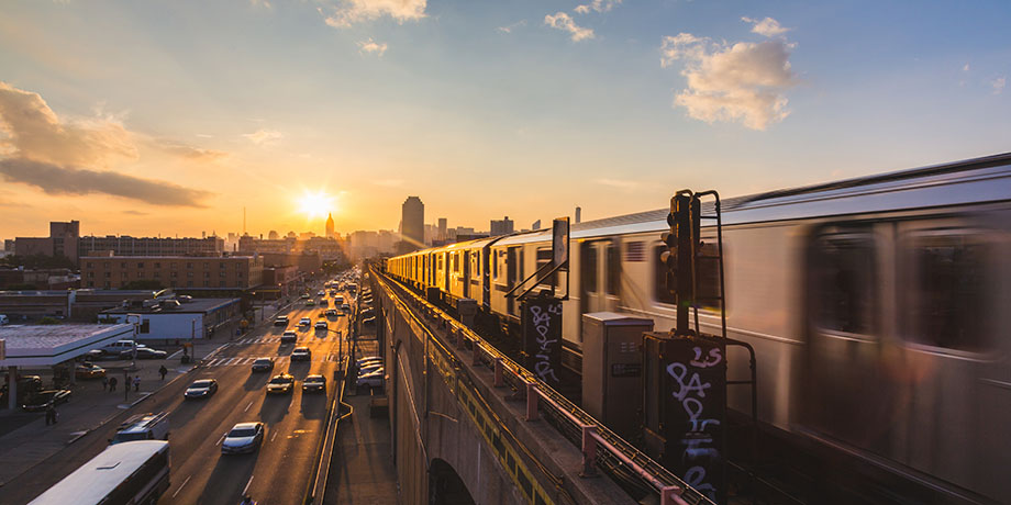 An image of a subway train moving through the borough of Queens
                                           