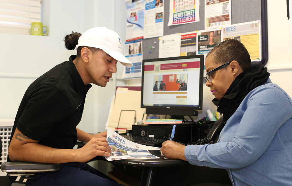 Employee of Jobs-Plus assisting a NYCHA resident with application