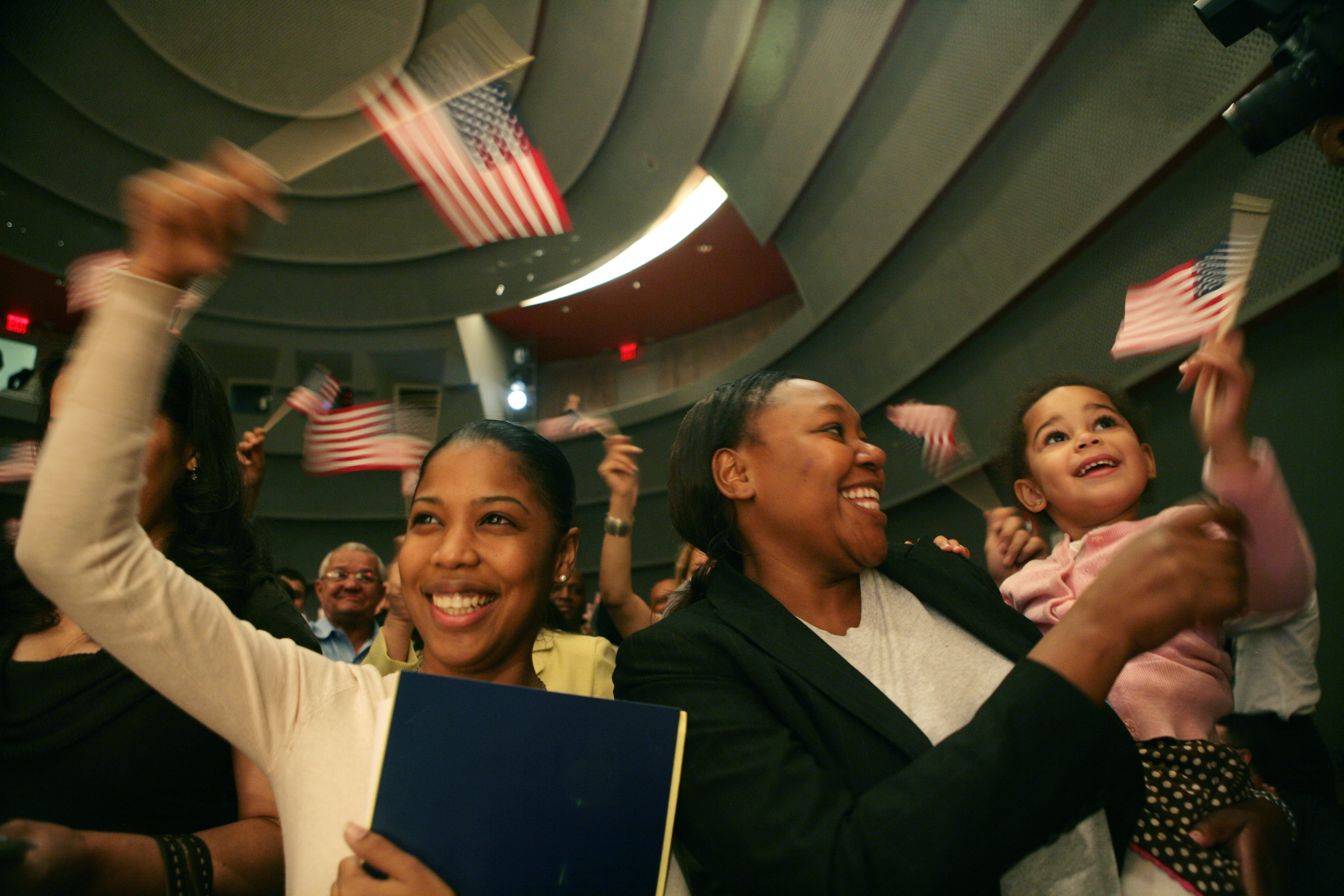 Group of people waving the US flag
                                           