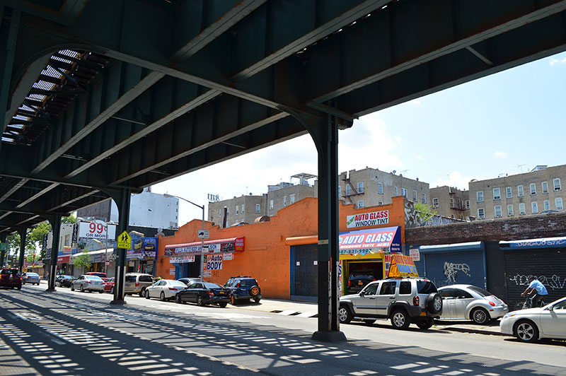 Storefronts shown on Jerome Avenue underneath the elevated subway tracks.”