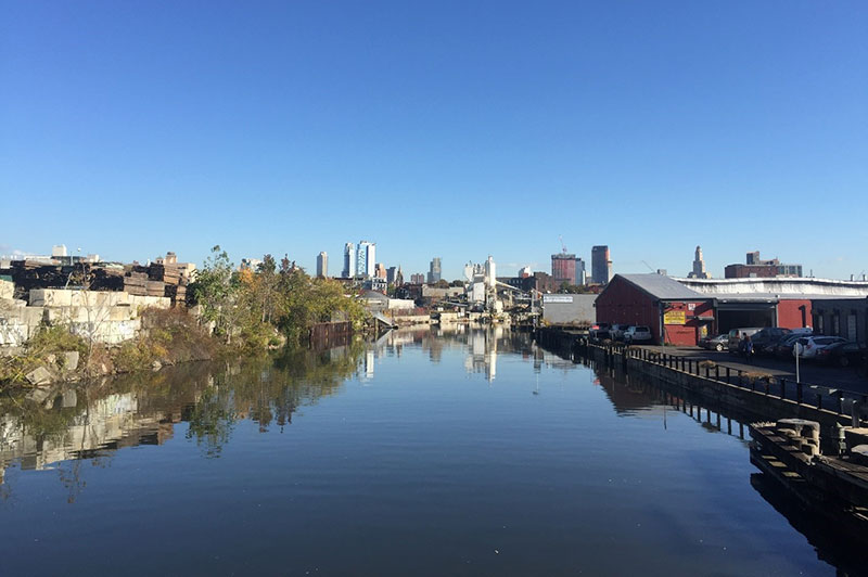 A view of the Gowanus canal in foreground with Downtown Brooklyn in the background.”