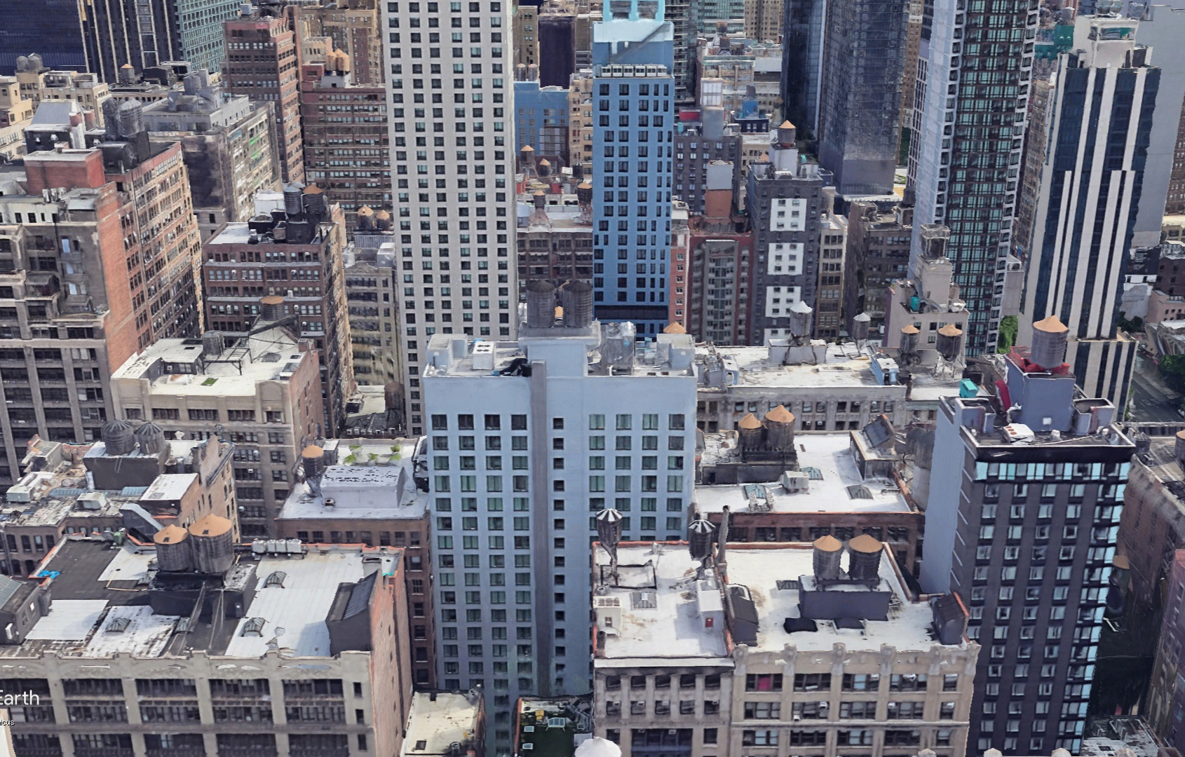 An aerial shot of Midtown Manhattan buildings taken during the day.