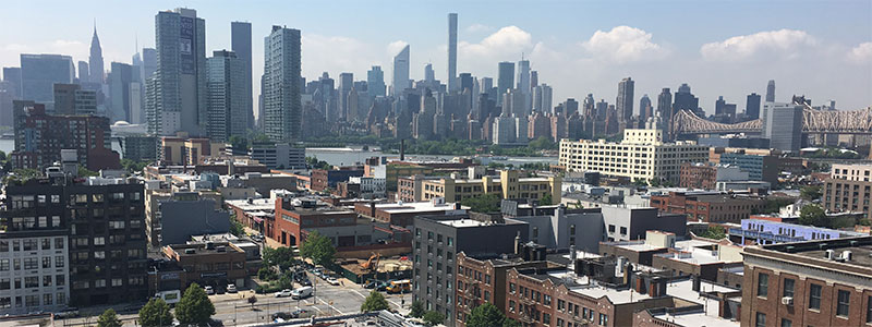 An aerial view of Long Island City showing the Manhattan skyline in the background.