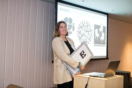 Emma Reed accepts her award for designing “Have a Seat,” the selection for the new official NYC POPS Logo.
