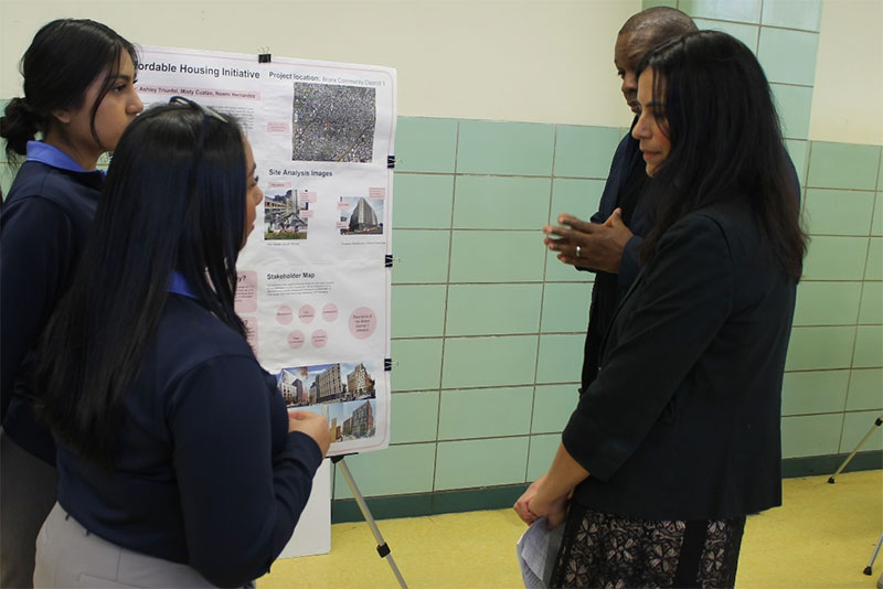 People looking at a board with images