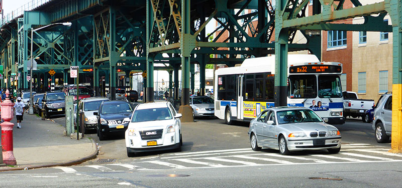 Pedestrian view of a road under elevated train tracks