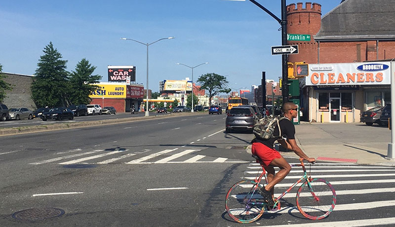 Man bicycling near a crosswalk