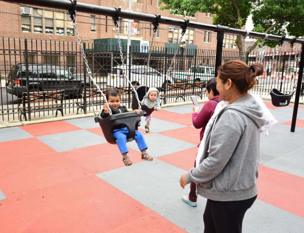 A child on a swing in an Elmhurst park
                                           
