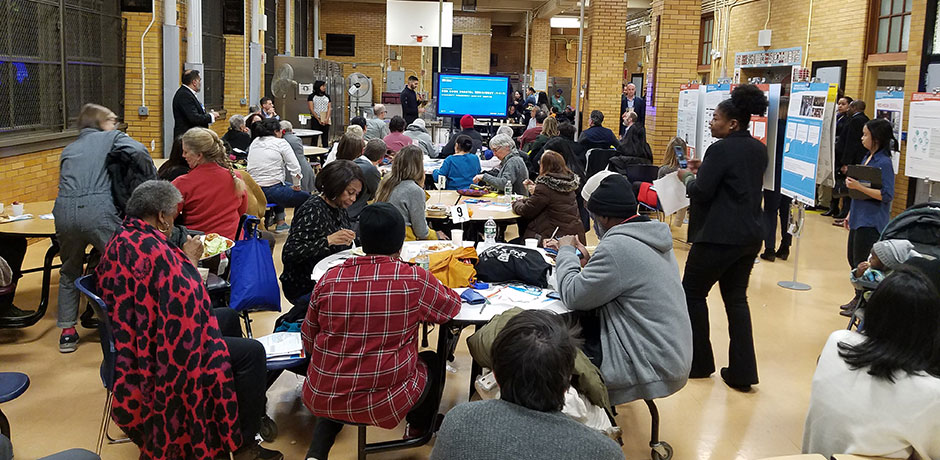 Photo of community members sitting around tables
                                           