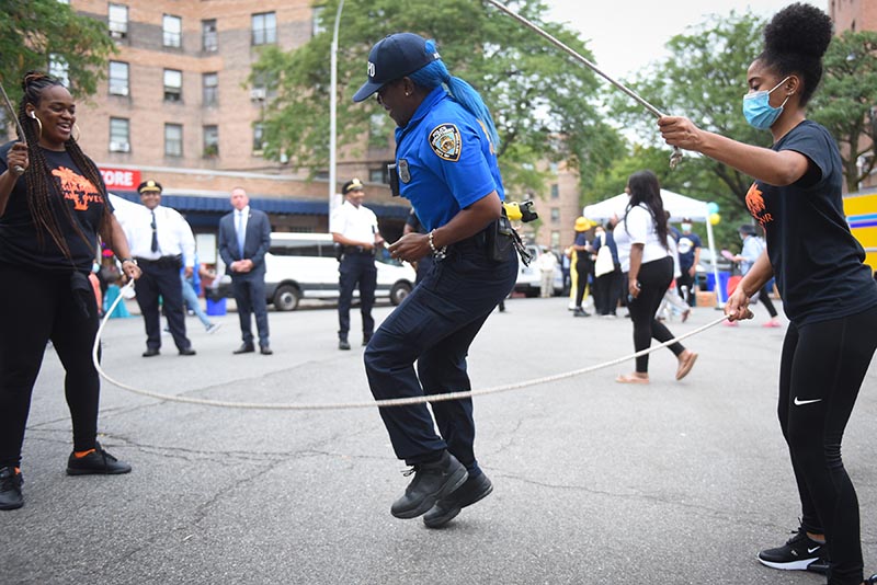 Policewoman playing double dutch in the park