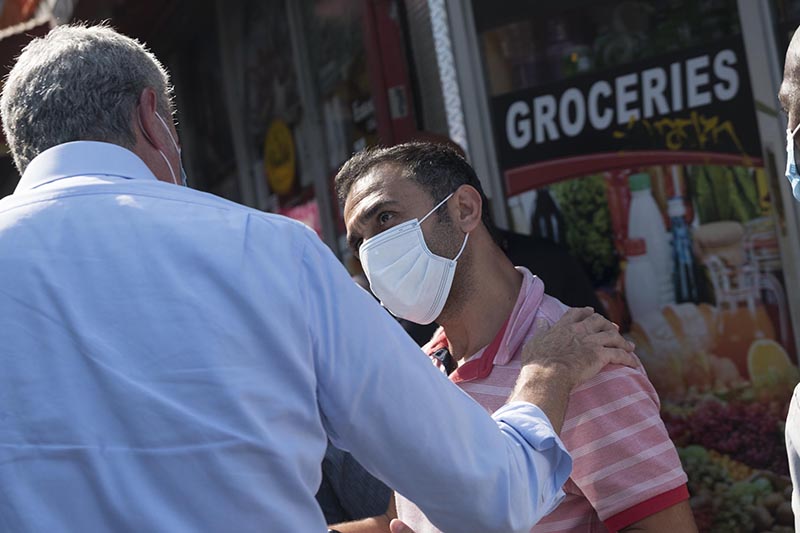 Bodega owner and man talking