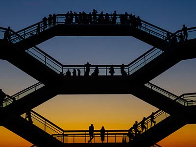 Photo of people at a sunset at an art installation