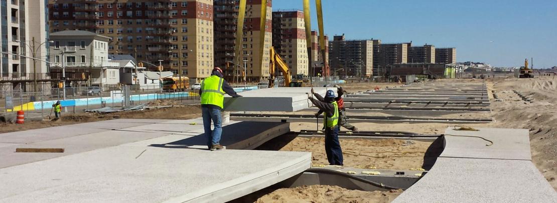 City workers rebuilding rockaway beach boardwalk.