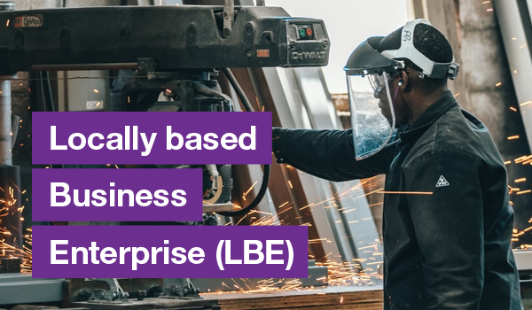 Black man using construction equipment with text on the left that says Locally based Business Enterprise (EBE)