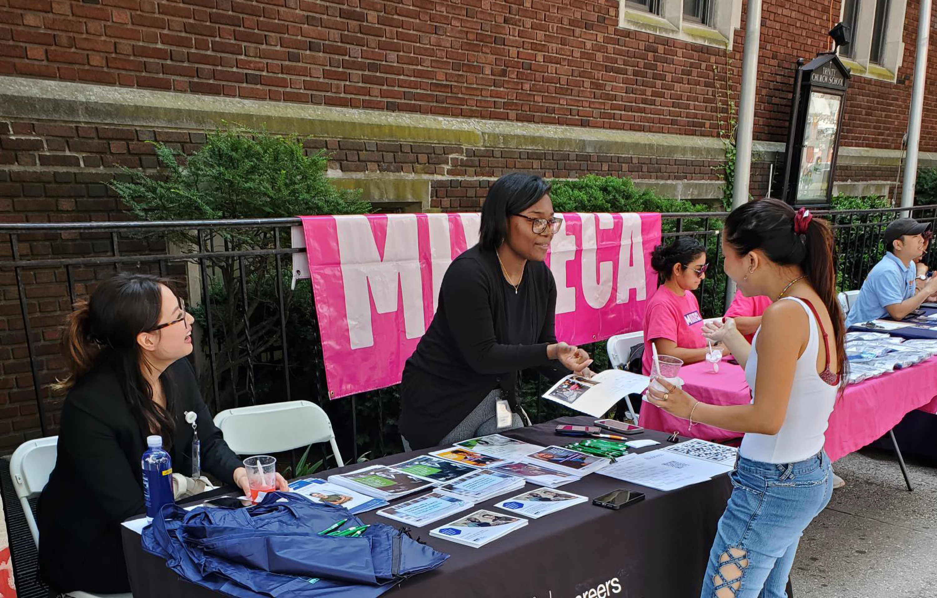 Outreach team showing SBS's services to a person.
                                           