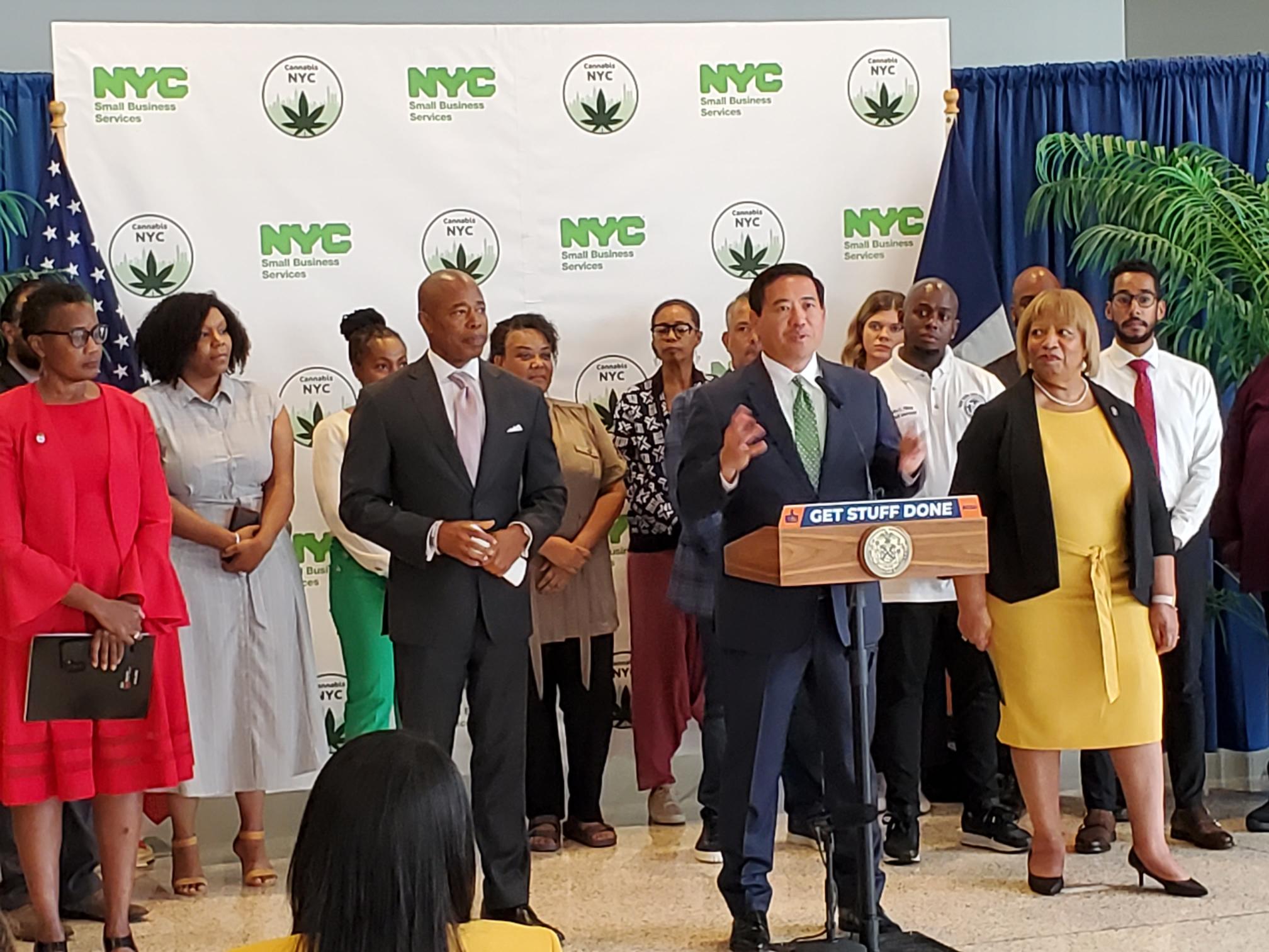 SBS Commissioner standing at podium with group of people including Mayor Adams
                                           