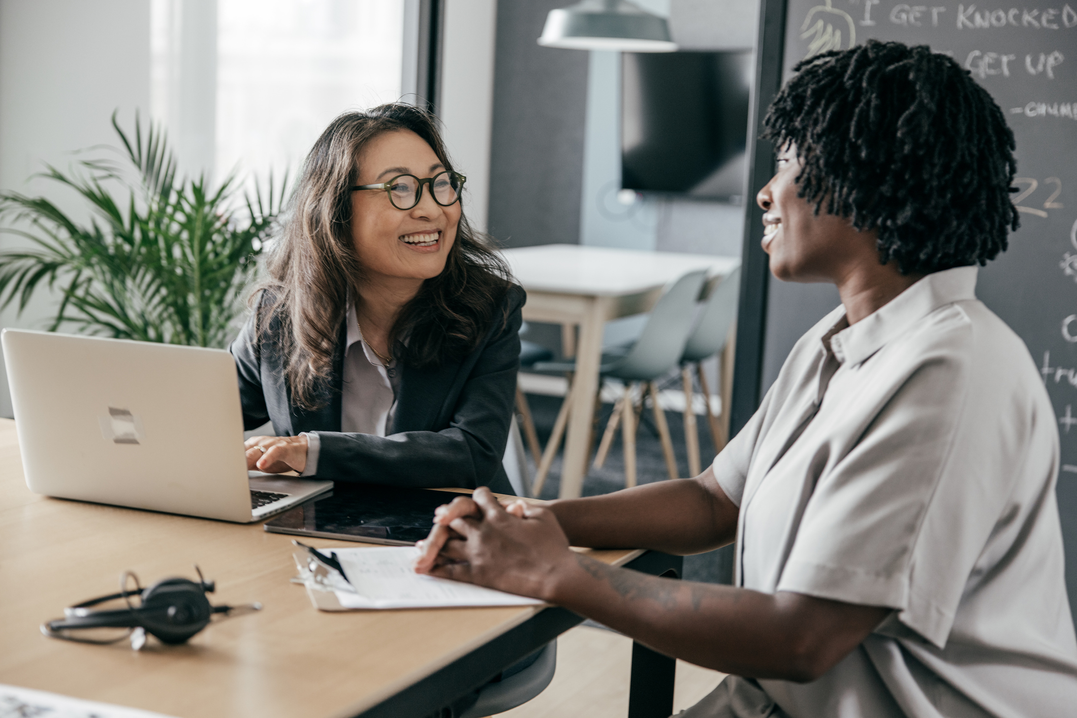 two women sitting at a desk having a business consultation
                                           