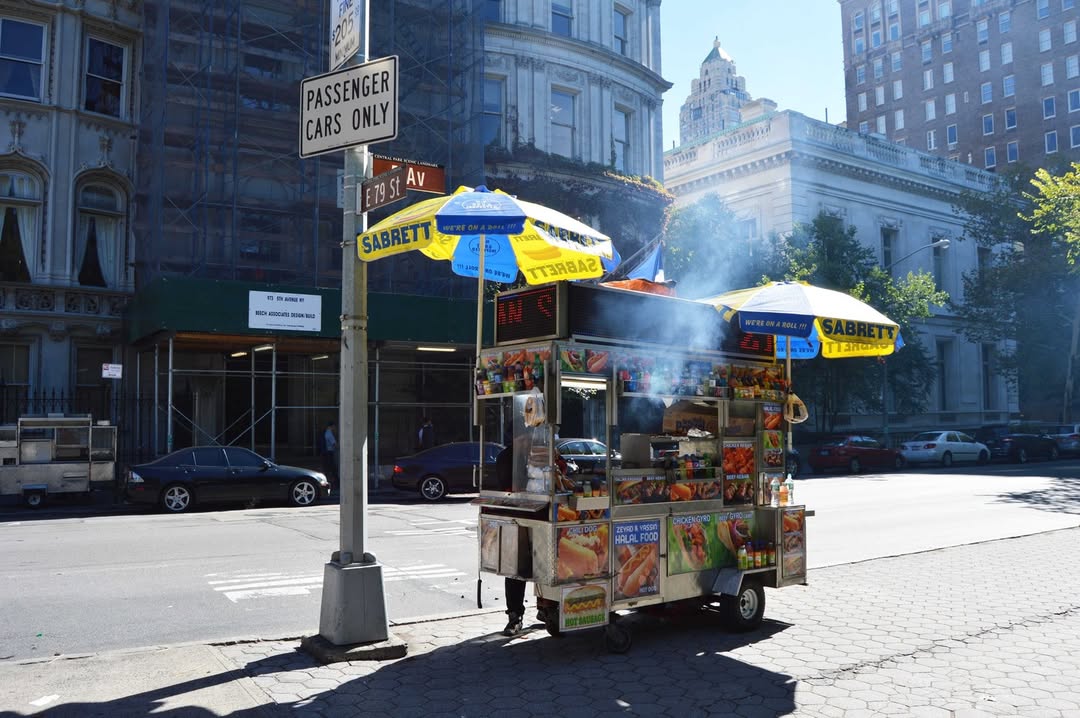 Street vendor on city sidewalk.
                                           
