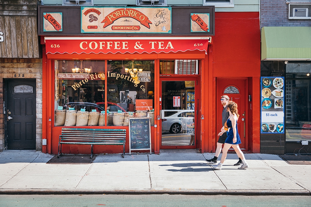 storefront on Grand Street in Brooklyn with two people walking by