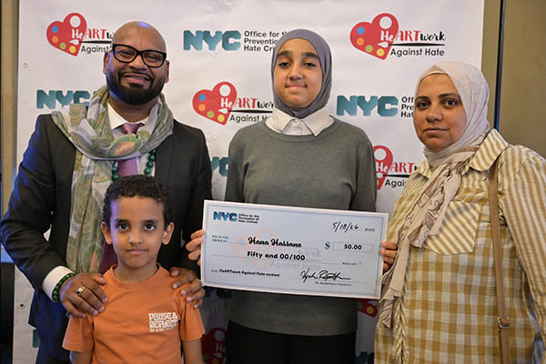 OPHC Staff stand with a winner and family smiling proudly