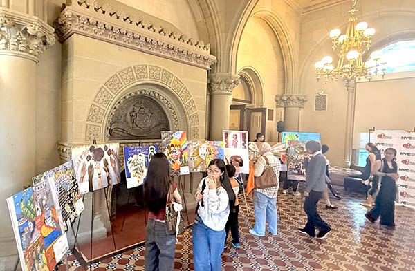 Photo of winners and family around the art display