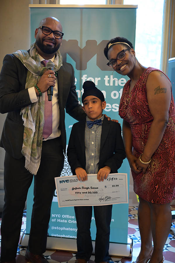 OPHC staff standing with young winner smiling proudly
