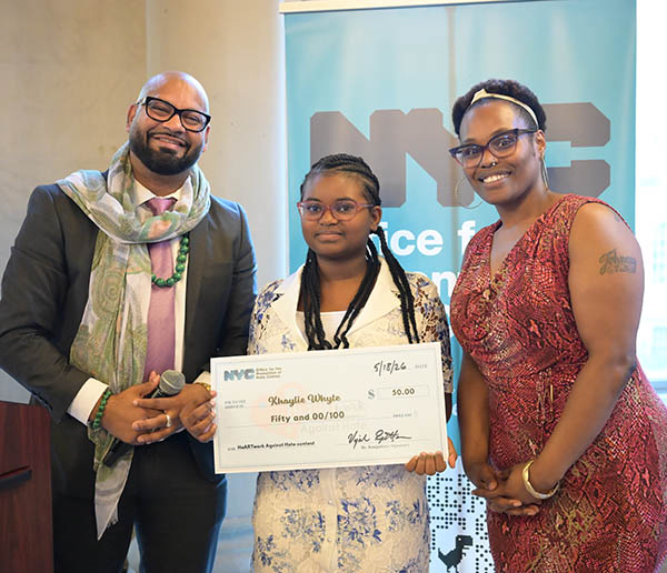 OPHC Staff and young winner stand close together smiling proudly