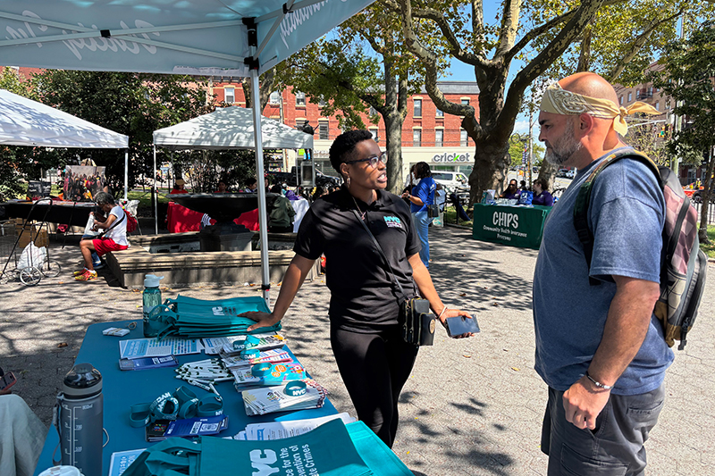 OPHC staff is speaking with community member at PATH Awareness Day