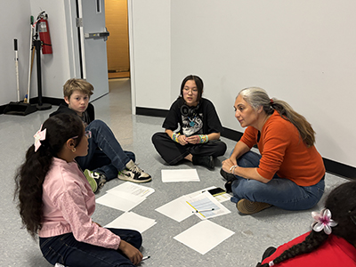 Mayor's Office of Criminal Justice mentor is meeting with group of students