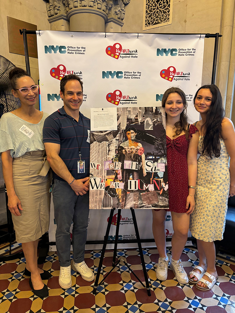 Student stands next to her artwork (collage) with her 3 family members