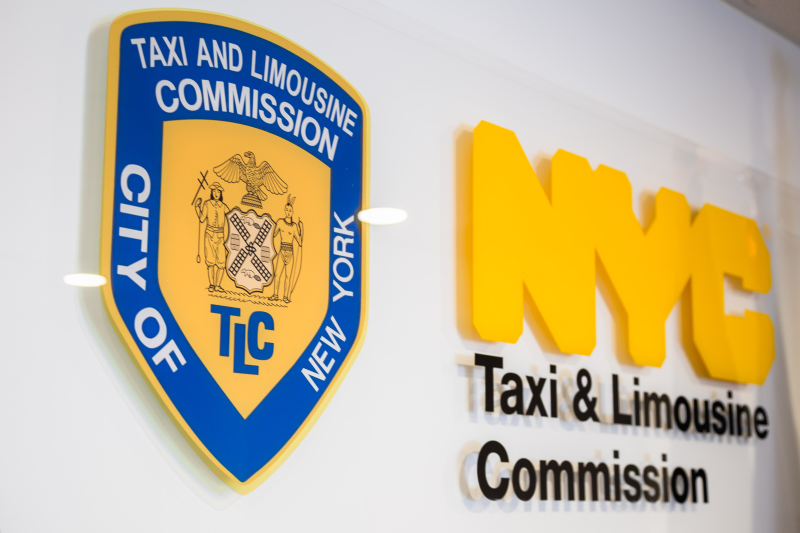 Image of a sign at TLC depicting TLC's Shield and the Wording NYC Taxi & Limousine Commission