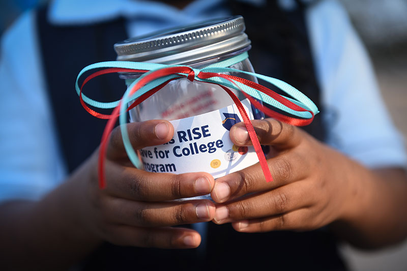 Child holding a donation jar