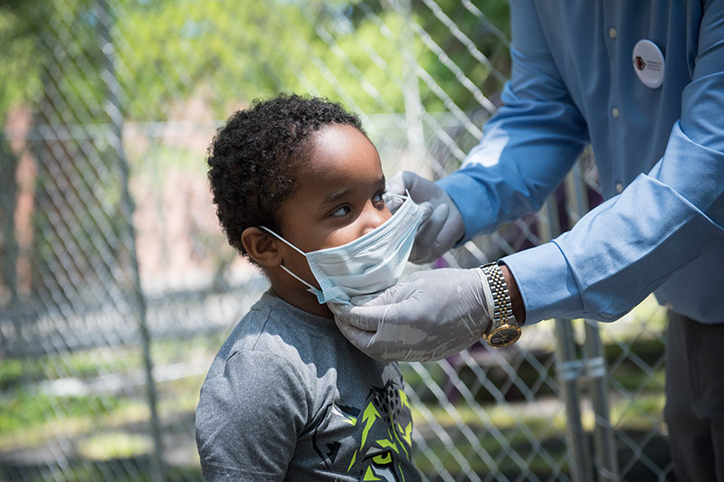 Photo of child with a mask