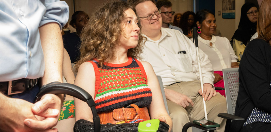 a woman with a mechanical attachment of her right hand at the center
                                           