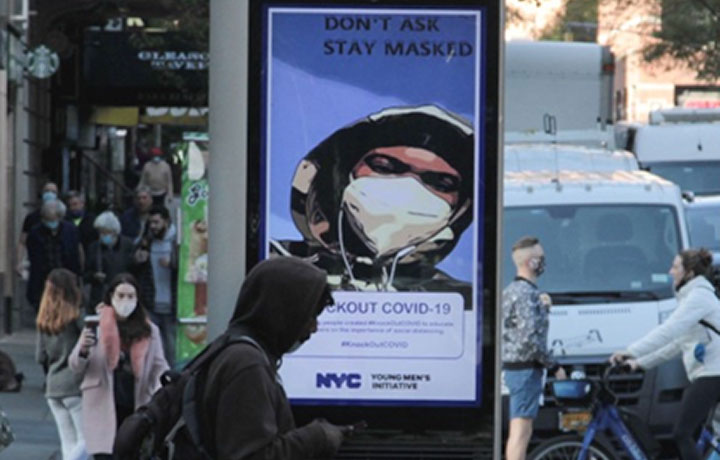 Photo of person walk in front of a LinkNYC Kiosk
                                           