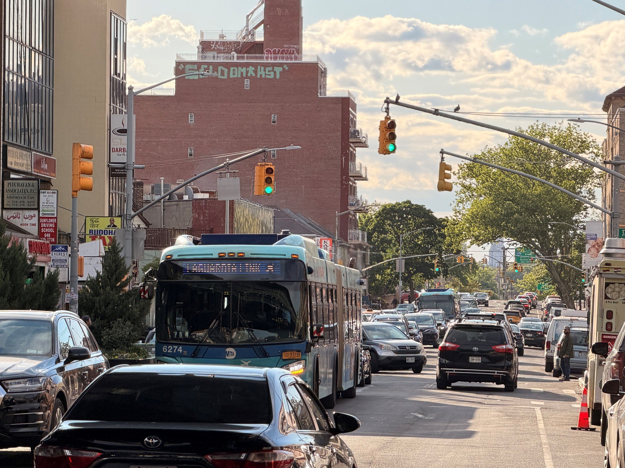 A Q70-SBS travels along Broadway in Jackson Heights, Queens.