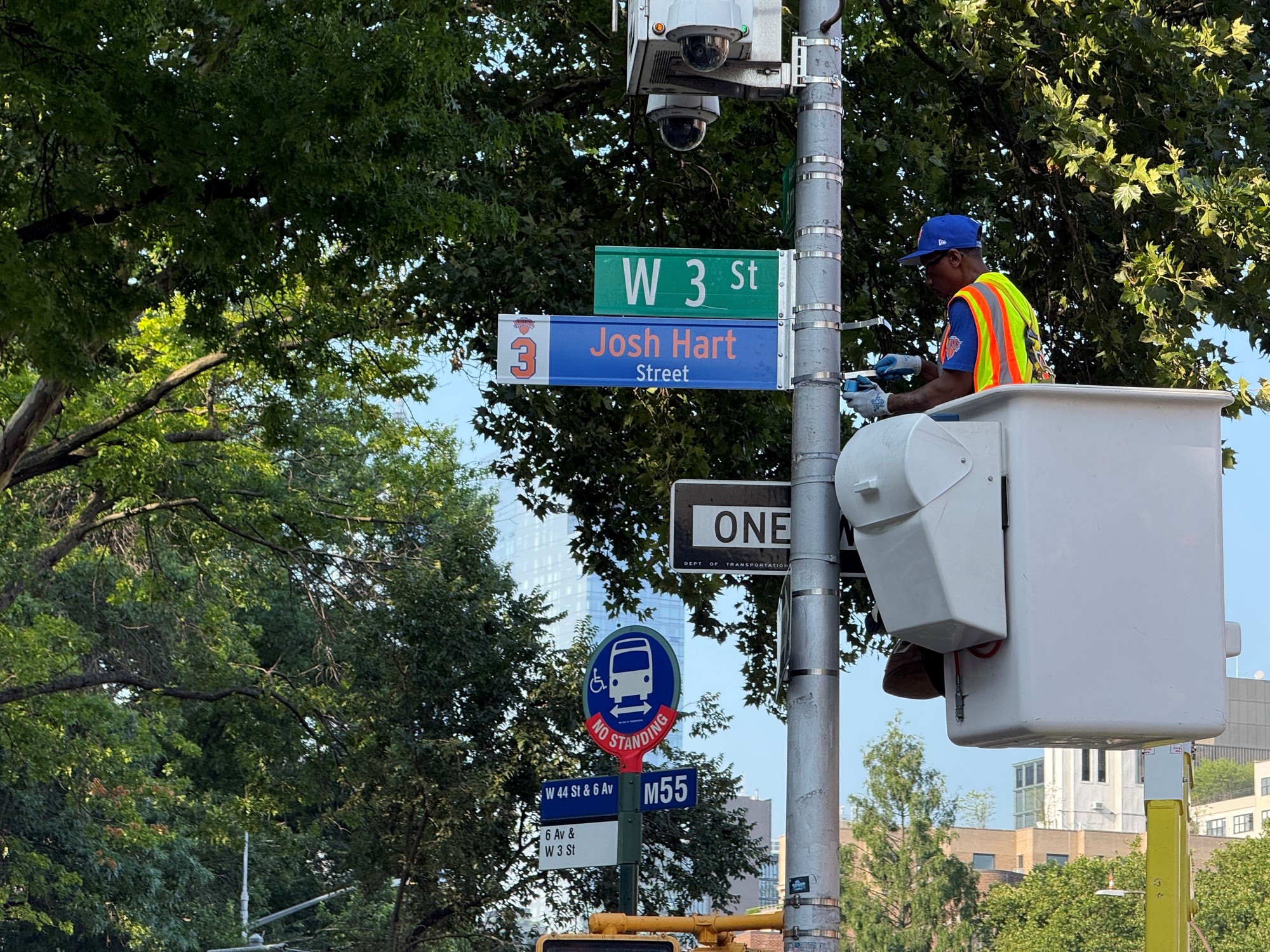 a worker is performing the signage change on scaling ladder.