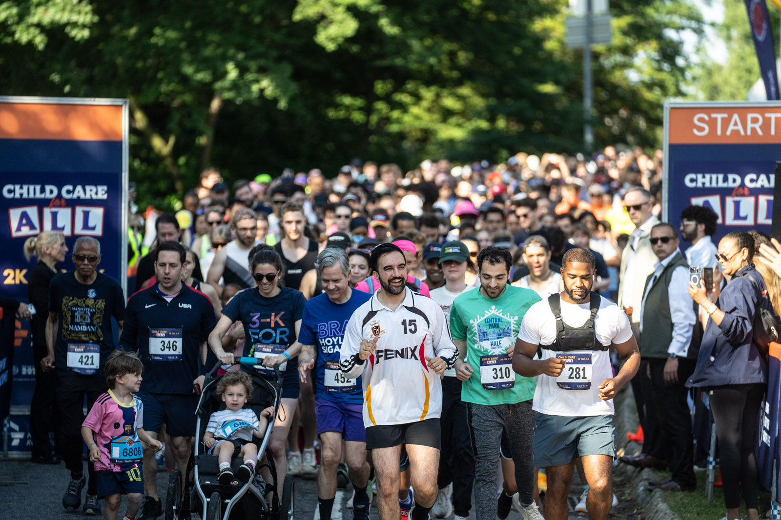 Mayor Mamdani, center, wears sporting cloth, leading a huge group of people running 