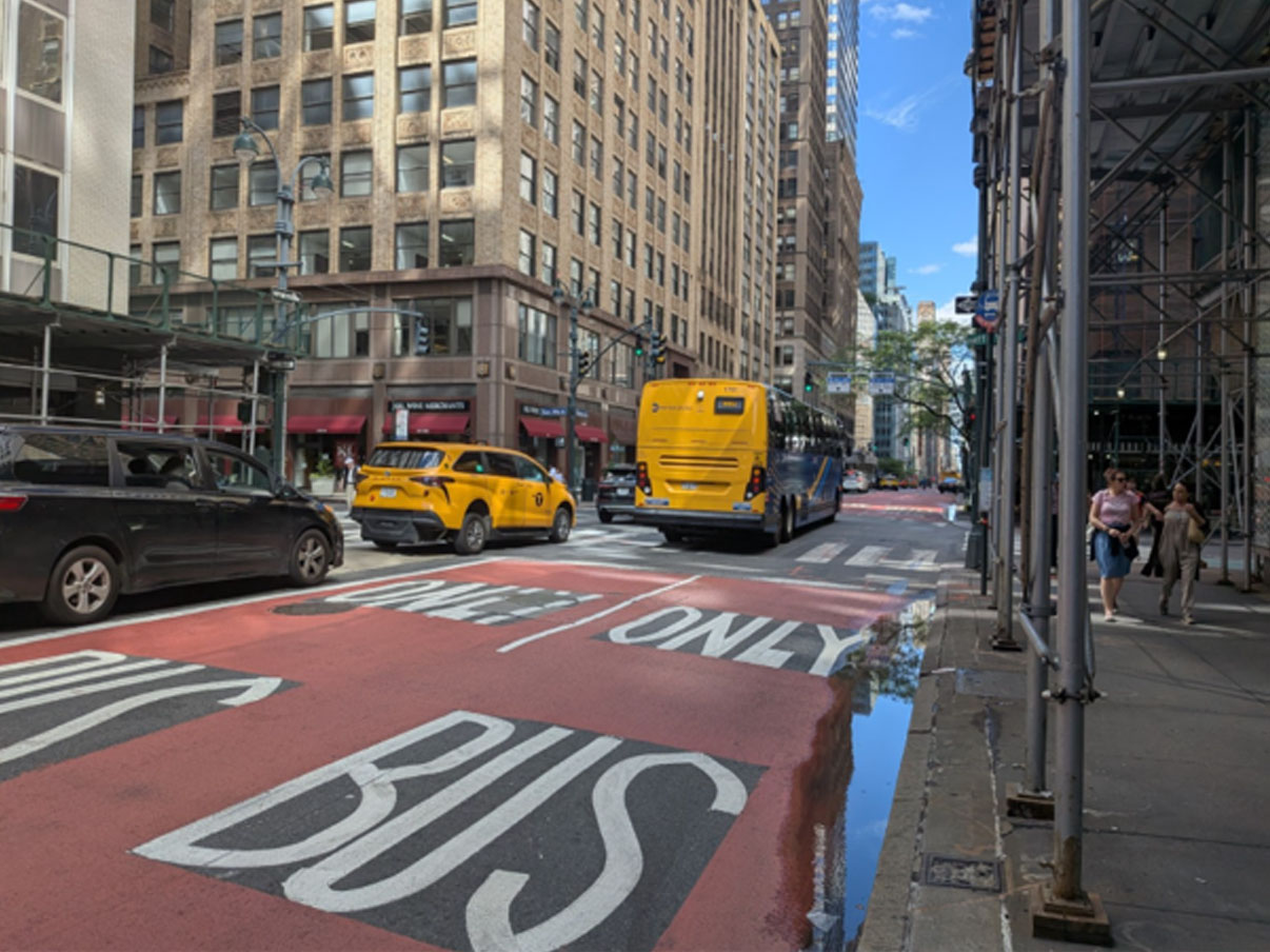 A road painted with red and text reads, "BUS ONLY"
