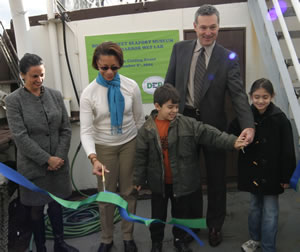 Commissioner David Tweedy helps to open the new Living Harbor Wet Lab on the deck of the Peking.